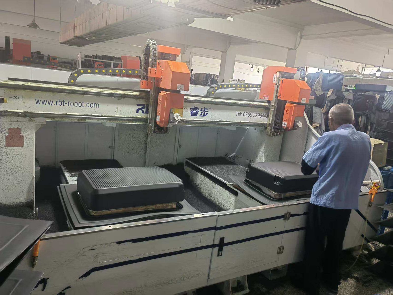 factory workstation showing luggage component cutting and material waste